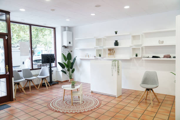 Spacious and bright waiting room with a modern and minimalist design, featuring a reception desk, comfortable chairs, and stylish decor