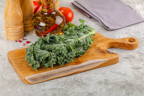 Vegan cuisine Green Kale cabbage leaves ocer board
