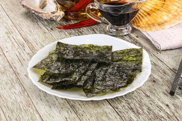 istock Green nori seaweed chips with soya sauce 2180431490