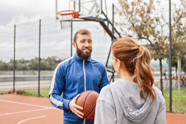 istock Young Couple Pausing After Fun Basketball Game 2180432594