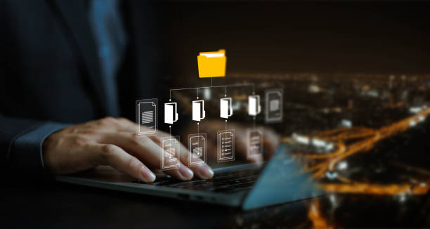 istock Businessman working with laptop computer with document management icons on virtual screen 2180433164