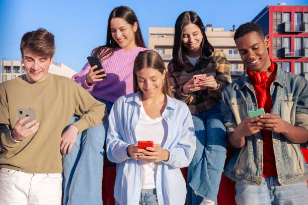 istock Students having fun with mobile phones creating content on social media. 2180433451