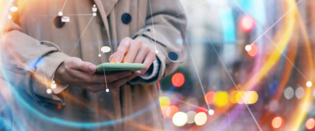 istock Young woman with smartphone in her hands. Outdoors. Global networking concept 2180433492