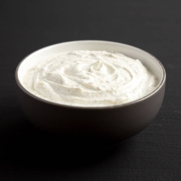 istock Homemade Ranch Dressing in a Bowl on a black background, side view. 2180438816