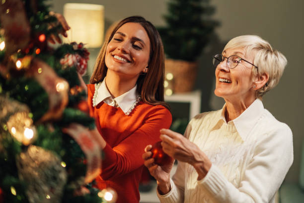 istock Happy family decorating christmas tree at home 2180441672