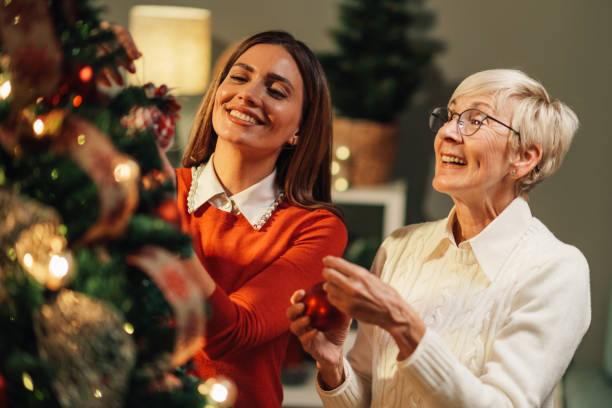 istock Happy family decorating christmas tree at home 2180441699