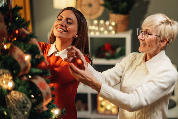 istock Happy family decorating christmas tree at home 2180441735