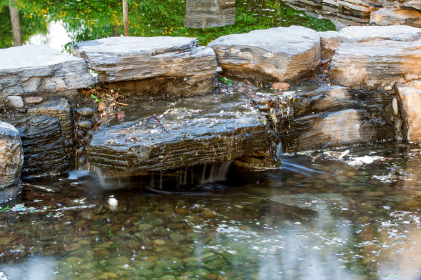 A stream tumbles down the mountainous hillside across rustic rock