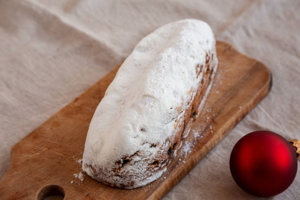 istock Homemade Christmas Stollen Bread on a rustic wooden board, side view. 2180443453