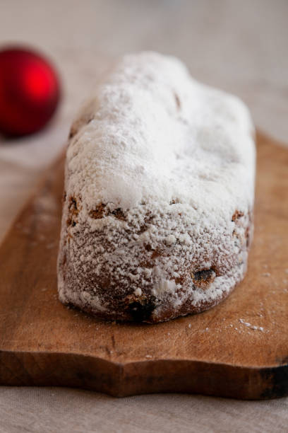 istock Homemade Christmas Stollen Bread on a rustic wooden board, side view. 2180443555