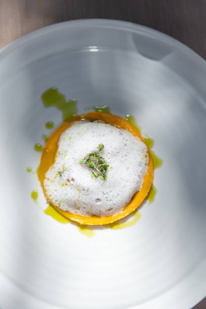 istock Michelin Fine dining restaurant dish tasting menu at elegant gourmet table plates with lobster tail, pumpkin and truffle foam 2180443639