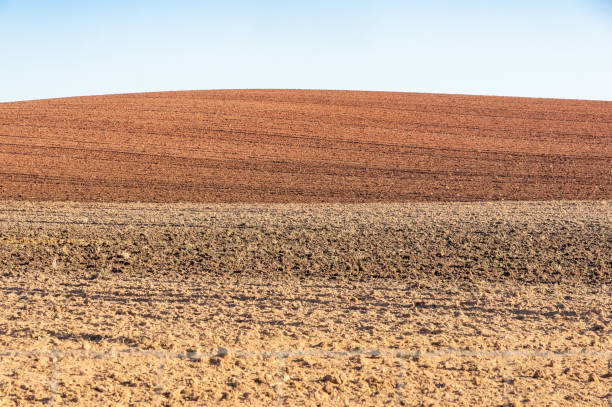 istock Agricultural horizon: contrast between blue sky and plowed red land. 2180446281