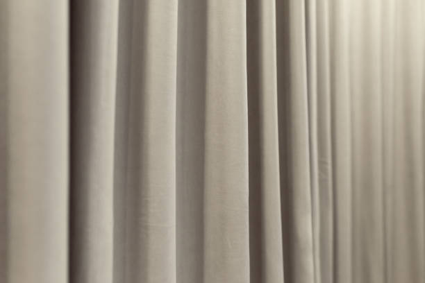 istock white curtain curtain that dropped down as a straight line. Background for inserting text, empty spaces 2180446970