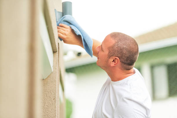 istock Handyman cleaning outdoor security camera with cloth 2180447149