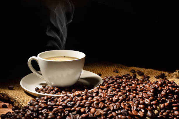istock Coffee cup and coffee beans with smoke on burlap sack 2180448016