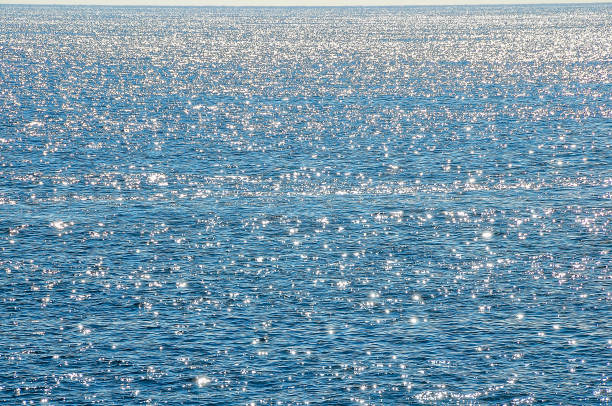 istock The water appears to be calm and still, with no visible waves or ripples 2180450816