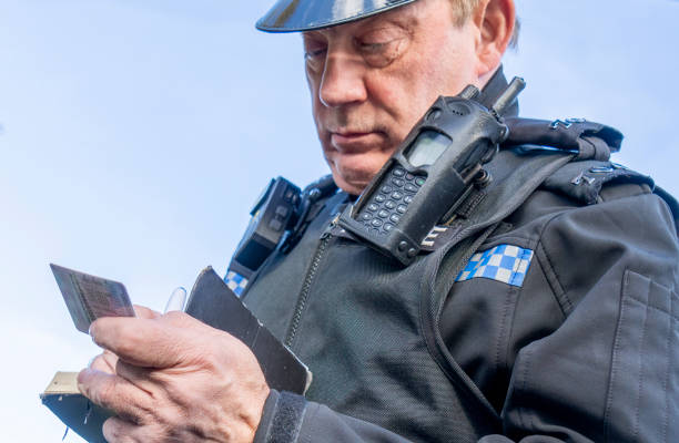 istock UK police officer taking notes at a parked car 2180451245