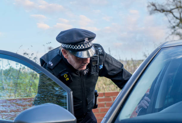 istock UK police officer approaching a parked car 2180451290