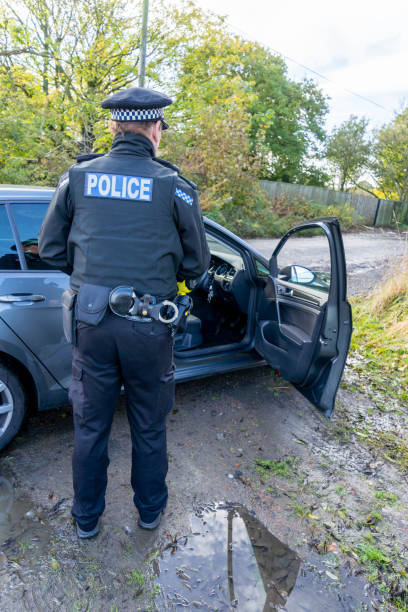 istock UK police officer approaching a parked car 2180451324