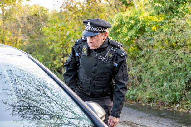 istock UK police officer approaching a parked car 2180451461