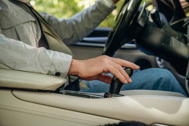 istock Side view of senior man that is driving a car 2180457485