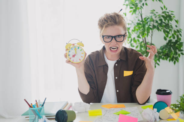 istock Photo of crazy stressed depressed girl hold alarm clock work hard task deadline schedule work from home indoors workplace workspace 2180460496