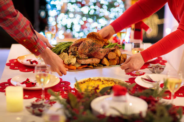 istock Family with kids having Christmas dinner at tree 2180462871
