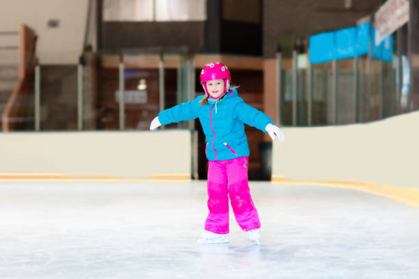 istock Child skating on indoor ice rink. Kids skate. 2180465751