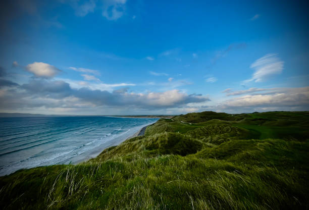 istock A cliff by the ocean with a grassy hill in the foreground 2180465848