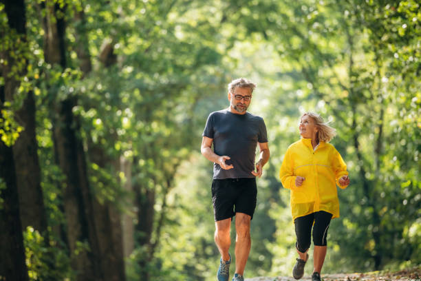 Casual jogging, sport conception. Senior couple together outdoors at nature stock photo