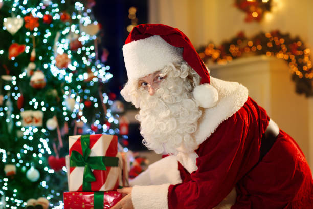istock Santa Claus on Christmas eve. Presents under tree. 2180466818