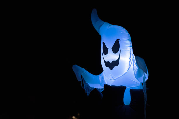 Halloween ghosts decorations at Halloween night on a city street. Trick or treat.