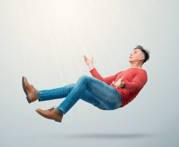 istock Situation, a confused man falls from heaven to earth, on a light blue background. 2180469498