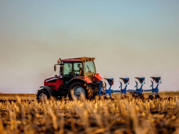 istock Tractor plowing and preparing stubble field for crop seeding 2180469579