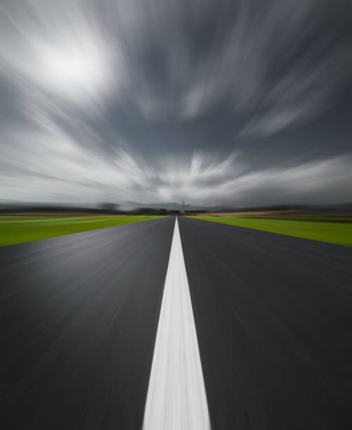 istock Long and winding road disappearing into the distance 2180471964