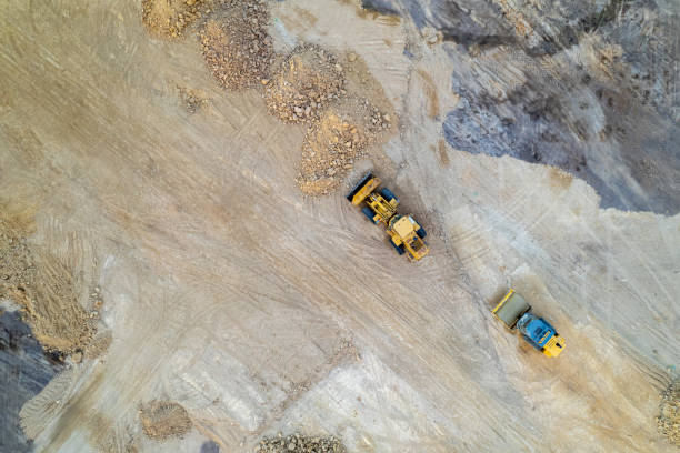 istock Aerial top view of earthmoving machinery working on a construction site 2180472999