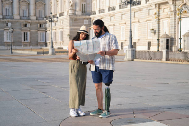 istock Tourists looking at map in front of building 2180473553