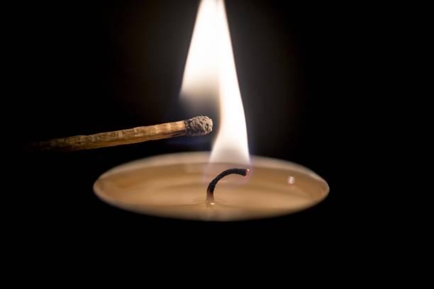 match lighting a candle in the dark