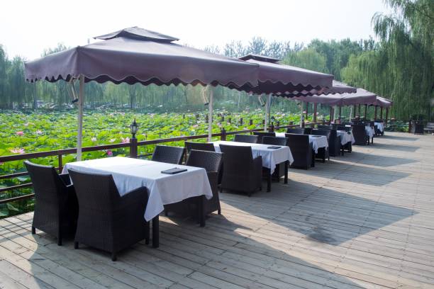 istock Terrace with tables and chairs by the lake 2180477707