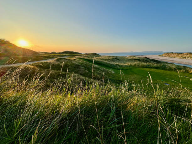 istock The sun sets over a golf course with a beach in the background 2180478602