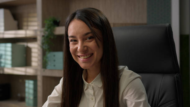 istock Happy smiling Caucasian office worker at workplace work with computer online chat clients business girl student employer female entrepreneur manager woman businesswoman typing laptop smile at camera 2180481498