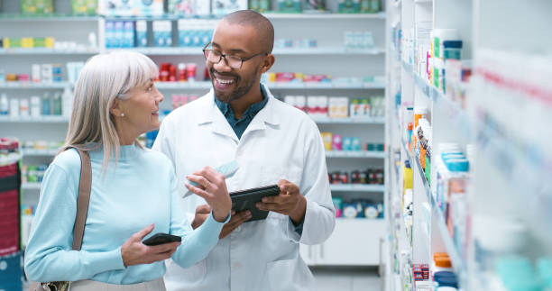 istock Pharmacist, help and customer service with tablet, healthcare and advice with pharmaceutical consultant. Shelf, inventory check and mature woman with supplements choice and deal in store for shopping 2180483030