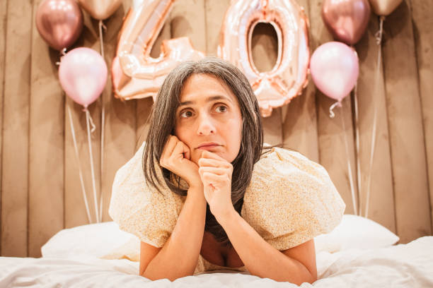 istock Thoughtful serious anxious mature woman feeling worried about problems of getting old. Middle aged grey haired lady looking away. Grown up princess in dress in age of forties 2180487947
