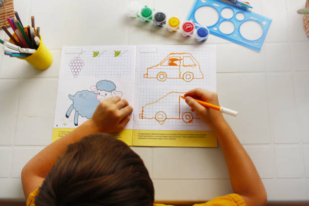 Child drawing car.Preschool, education, study in class room,child, coloring book. High quality photo