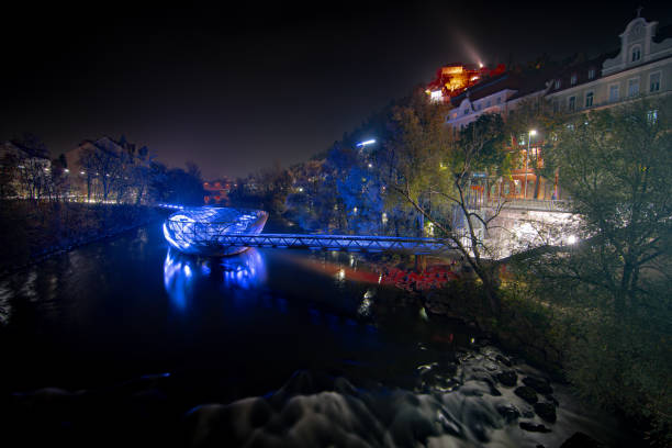 istock A stunning bridge illuminated over a river, showcasing its beauty at night 2180496032