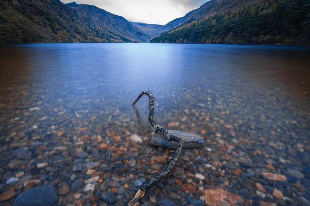 Glencoe mountains covered in mist with rough lake water under an overcast sky