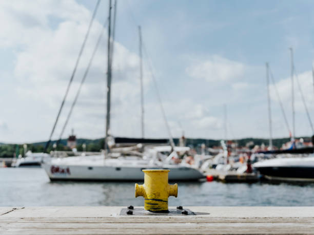yellow rusty bollard on the quay. passenger ferry pier. sea in the background. High quality photo. Sopot, Poland 18 august 2023