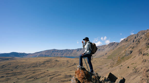 istock Hiker woman climbing the mountain 2180500256