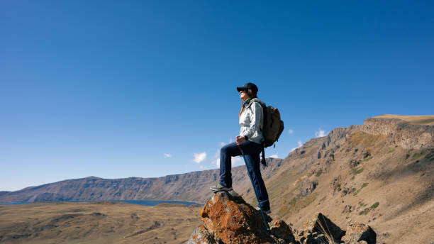 istock Hiker woman climbing the mountain 2180500367