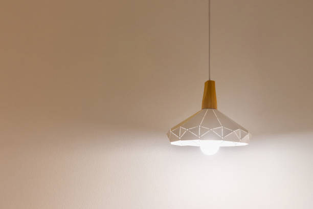 istock Hanging lamp from the ceiling that lights up the room. Copy space background texture 2180501098